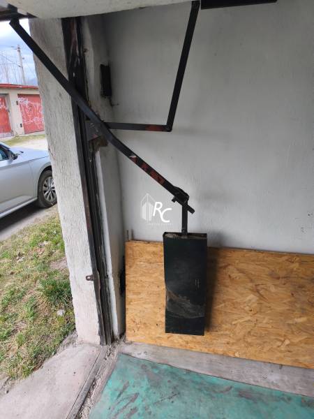 The interior of the garage with a wooden decor, detail on the door mechanism.
