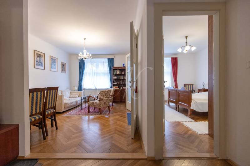Living room and bedroom in a 3-room apartment with a wooden decor floor.