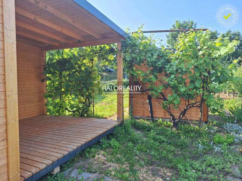 A wooden gazebo surrounded by greenery in the gardens of Bojnice.