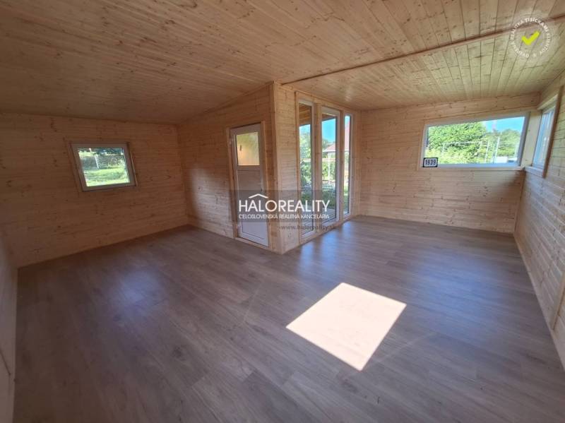The interior of a wooden cottage with light wood, large windows, in Gardens for relaxation.
