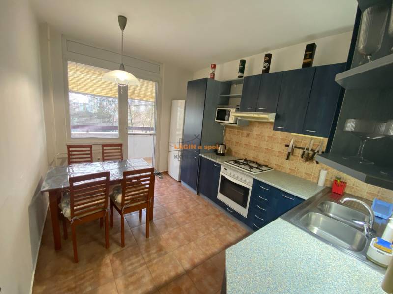 Kitchen in a 3-room apartment with a dining table and kitchen unit.