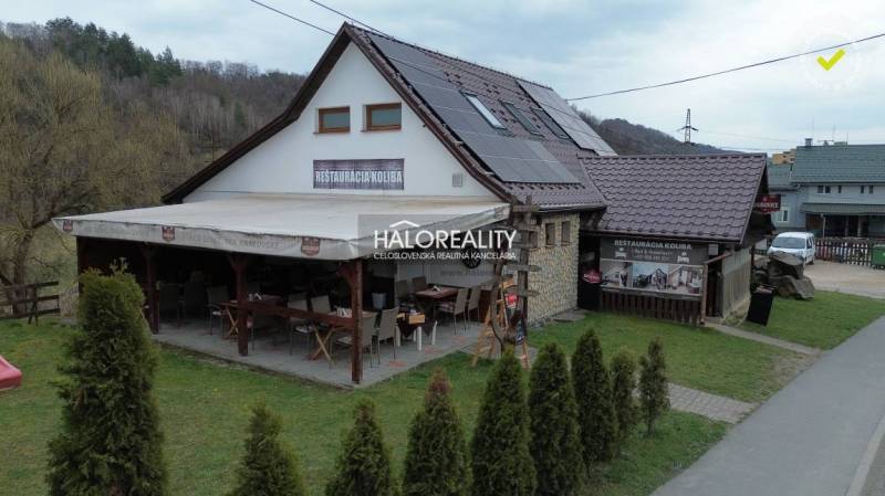 Gastro premises in Hnúšťa with a terrace, solar panels, and a stone exterior.