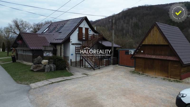 Gastro premises in Hnúšťa with parking and buildings in a natural environment.