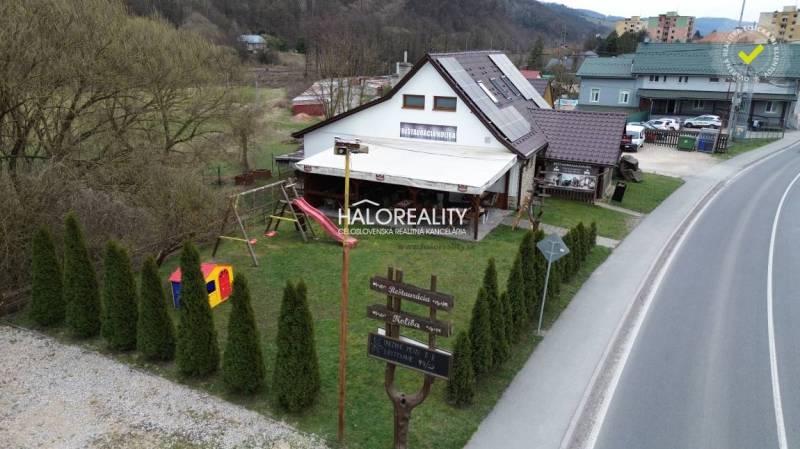 Restaurant gastro premises in Hnúšťa with a playground and surrounding greenery by the road.