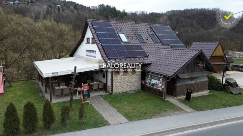 A restaurant in Hnúšťa with outdoor seating and solar panels offers dining spaces.