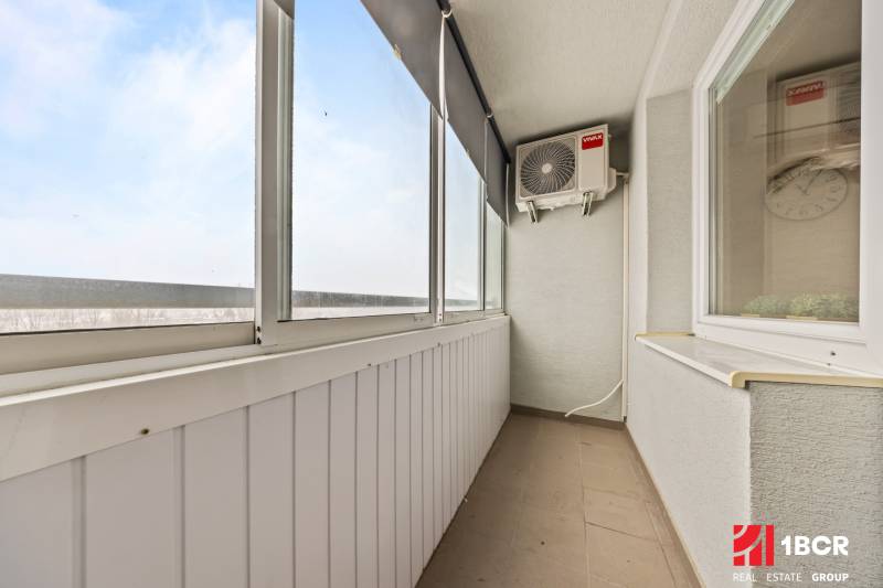 Glazed balcony in a 3-room apartment with air conditioning and a view.