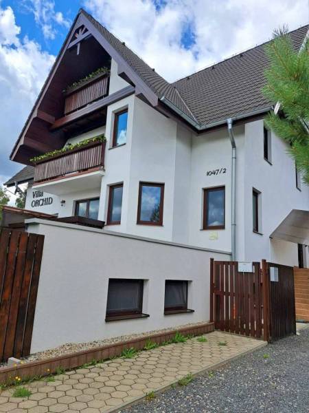 A villa with wooden balconies and a brown roof in Veľká Lomnica.