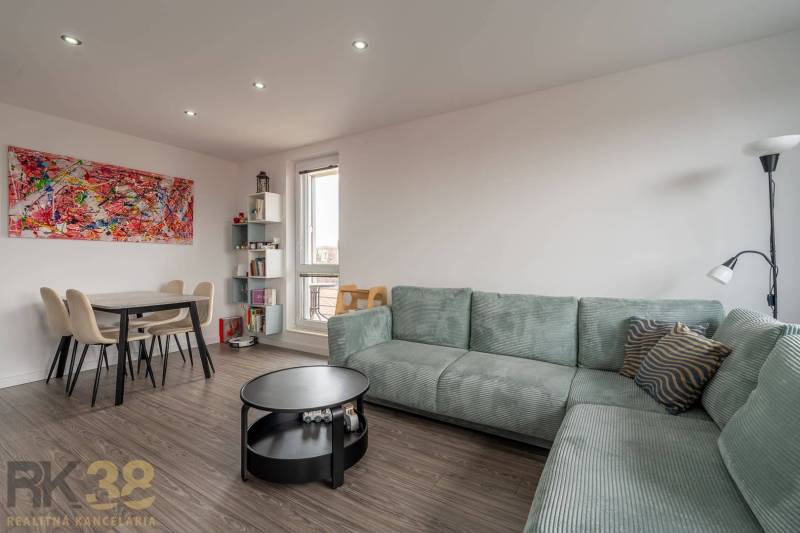 A stylish living area in a 4-room apartment with a wooden decor floor.