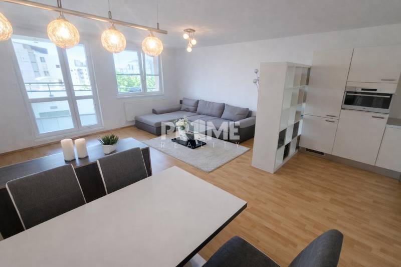 Living room with kitchen, sofa set, and wooden decor flooring in a 2-room apartment.