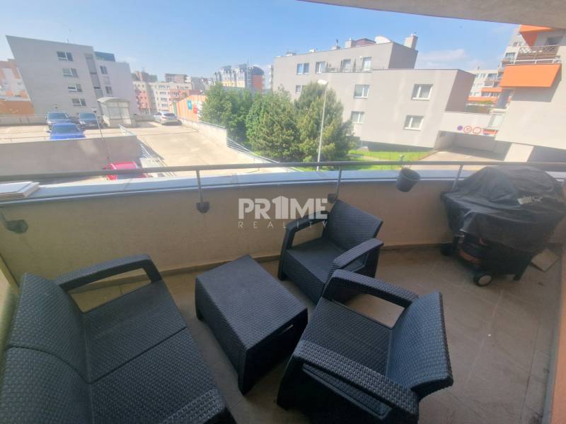 The balcony of a 2-room apartment with plastic furniture, overlooking the surroundings of Majerníková in Karlova Ves.