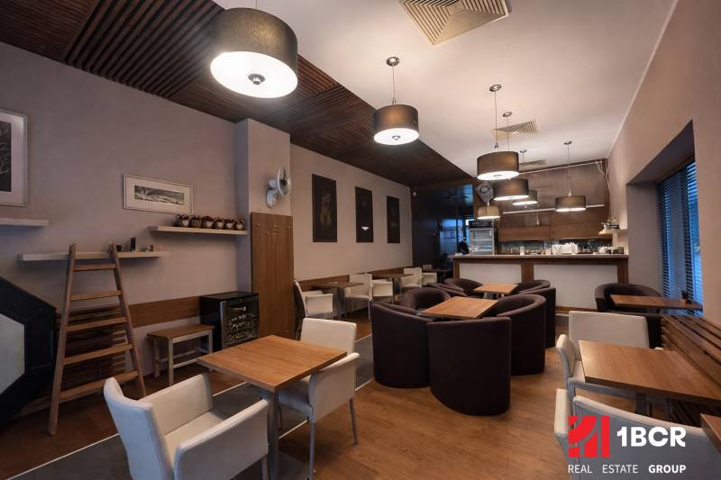 Interior of commercial spaces with comfortable chairs and tables, floor with wooden decor.