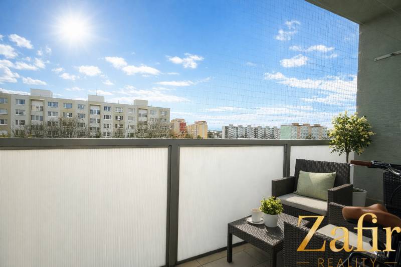 The balcony of a one-room apartment on Golianova Street in Trnava with comfortable seating and a view.