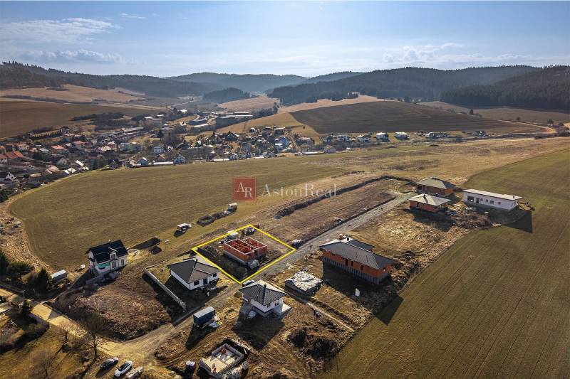 A view of the under-construction family houses in Tvarožná, surrounded by picturesque countryside.