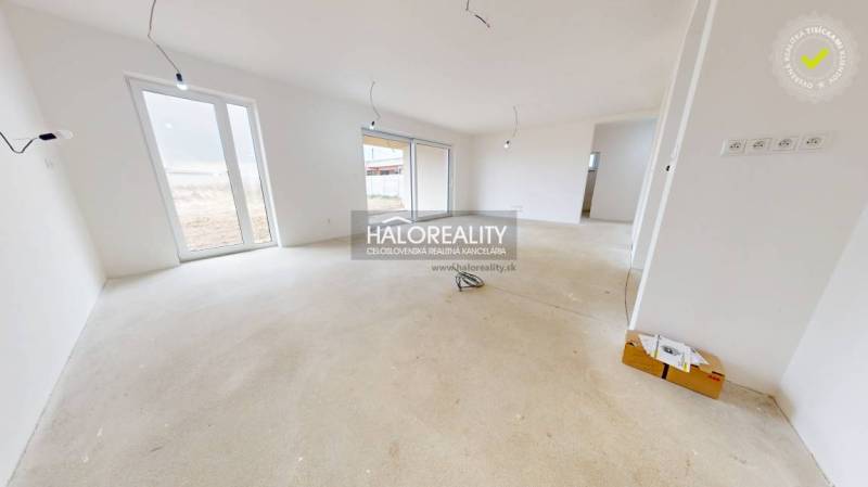 The interior of a family house with large windows, ready for completion.