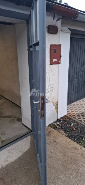 Open metal gate in the garages on Prachatická Street in Zvolen.