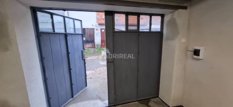 Open garage door with a view of the yard, Zvolen, Prachatická.