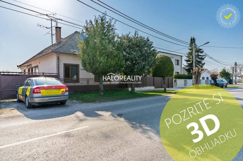 A family house in Horná Potôň with a parking lot and a well-maintained garden by the road.
