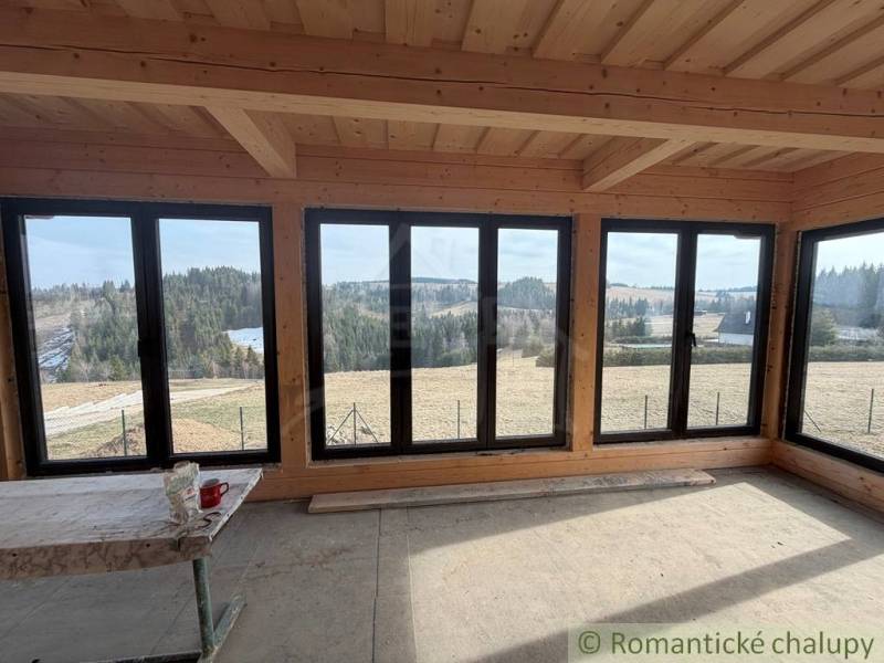 Windows with a view of nature in a family house, overlooking hills and forests.