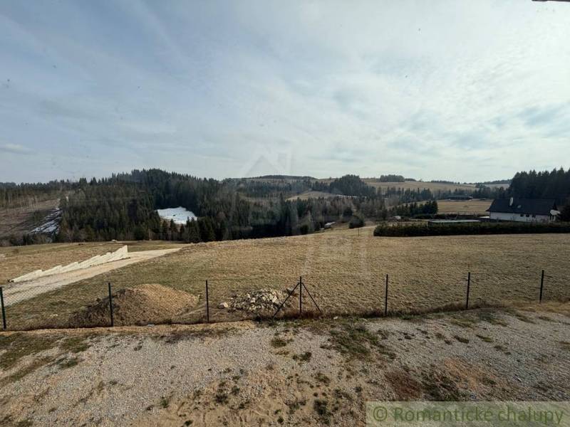 A picturesque landscape near a family house in Lom nad Rimavicou, with distant forests and meadows.