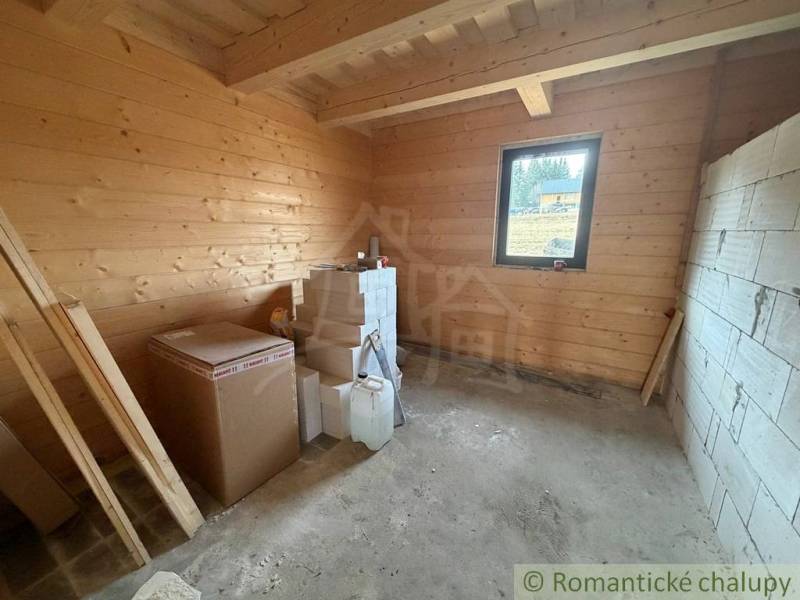 The interior of a family house with wooden paneling and building materials in the room.