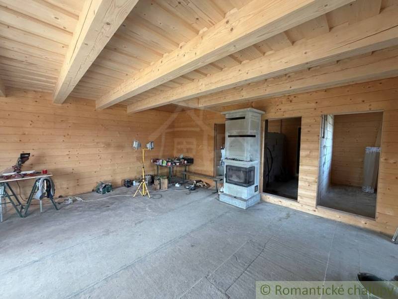 Wooden cladding, fireplace, and work materials in the interior of a family house.