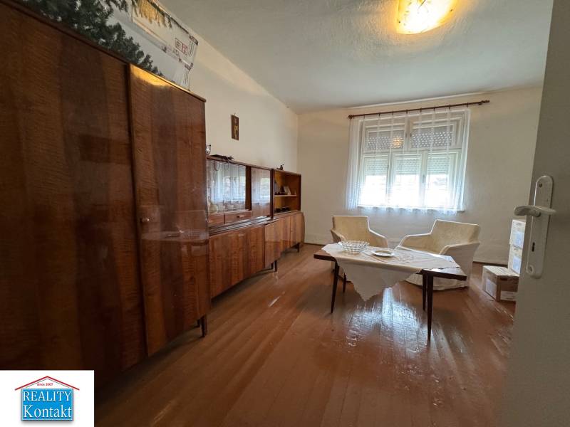 Living room in a family house with furniture and flooring with a wooden decor.