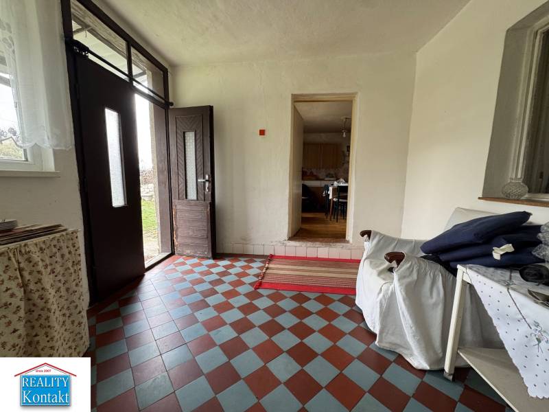 Entrance hall with tiled floor and furnishings in a family house.