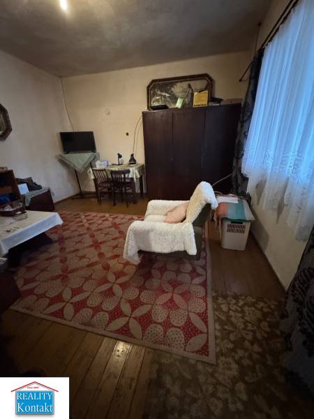 Living room in a family house with a carpet and flooring with a wood decor.