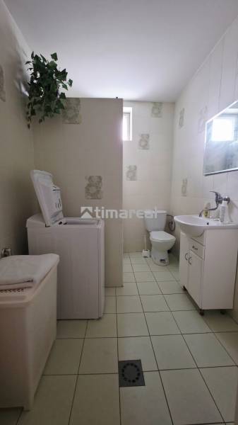 Bathroom in a family house with a washing machine and a sink.