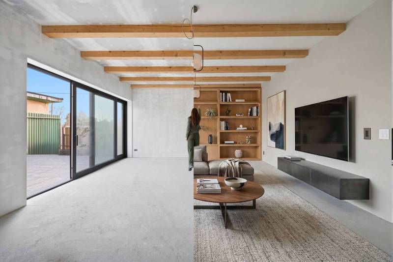Living room in a family house with wooden beams and large glass doors.