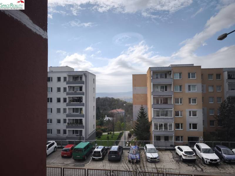 A view of apartment buildings and a parking lot on Mozartova Street in Bratislava - Old Town.