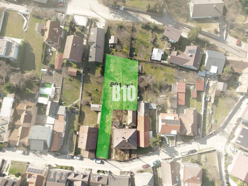 Aerial view of a plot in Marianka suitable for living, surrounded by buildings.