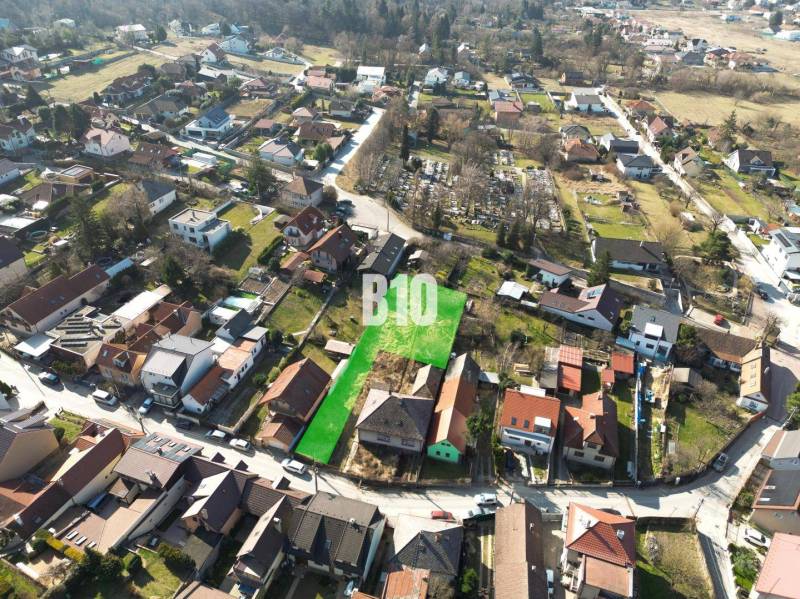 Aerial view of residential plots in Marianka, surrounded by houses and greenery.