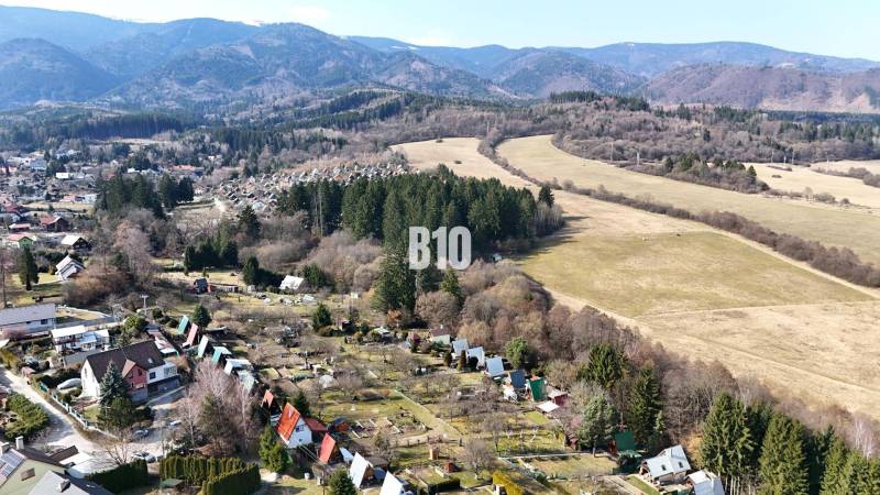 An aerial view of cottages in Martin surrounded by forests and meadows.