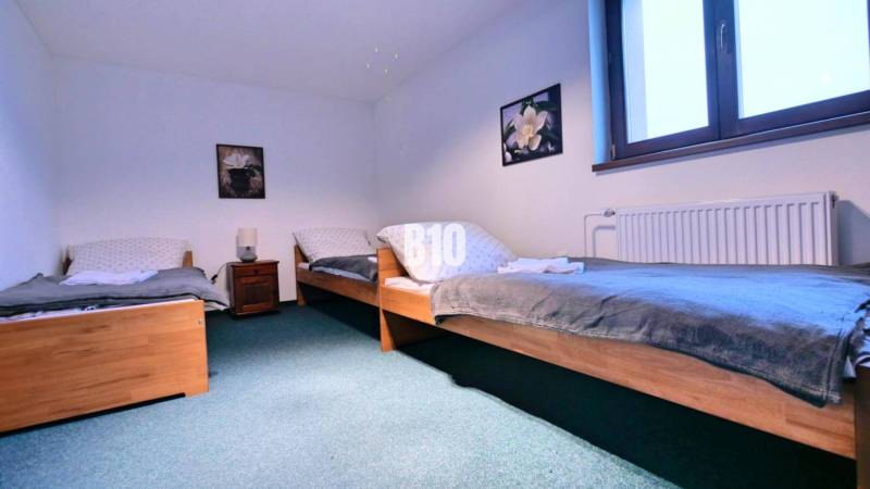 A bedroom with three beds and placed decorations in a 3-room apartment.