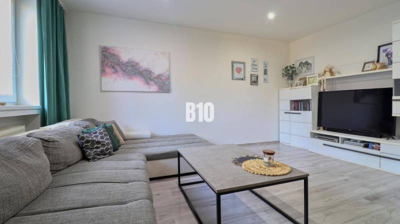 Living room with a comfortable couch and wall decorations in a two-room apartment.