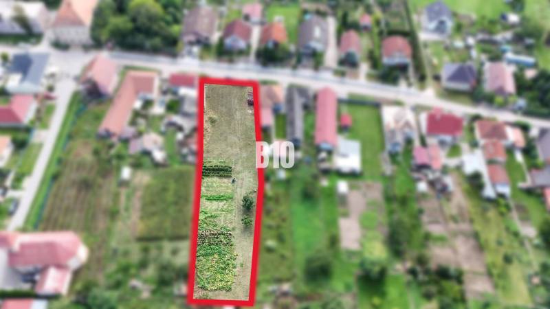 Aerial view of a plot in Rumanová suitable for living, surrounded by houses.