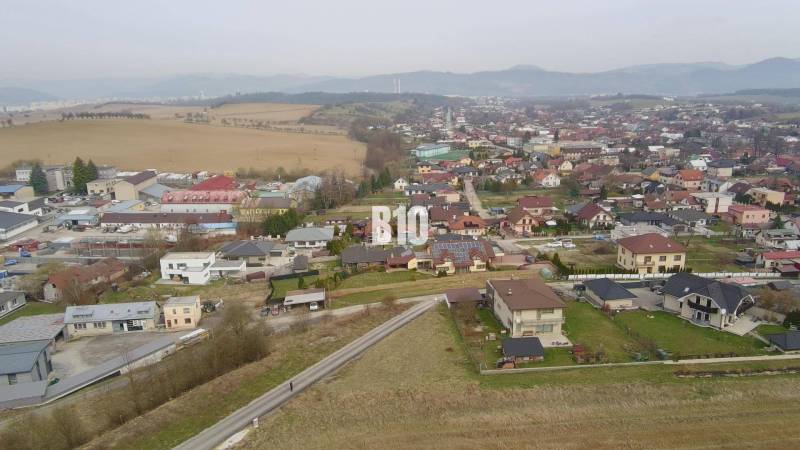 Aerial view of a residential area in Rosina with houses and greenery. Plots - housing.