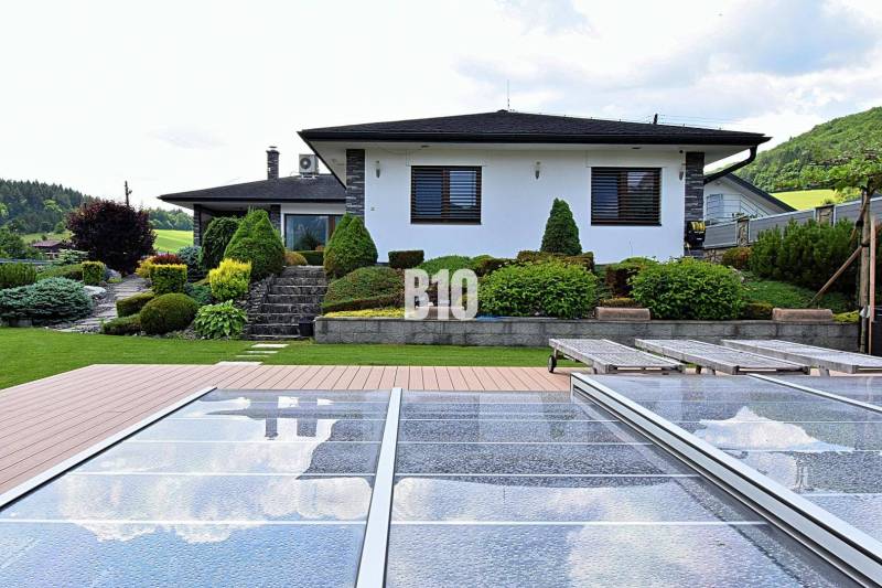 Villa in Súľov-Hradná with a pool, terrace, and landscaped garden.