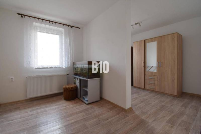 Interior of a family house with an aquarium, a wardrobe, and a wooden floor.