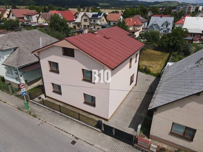 A family house in Bytča with a sloped roof and a yard in a built-up area.