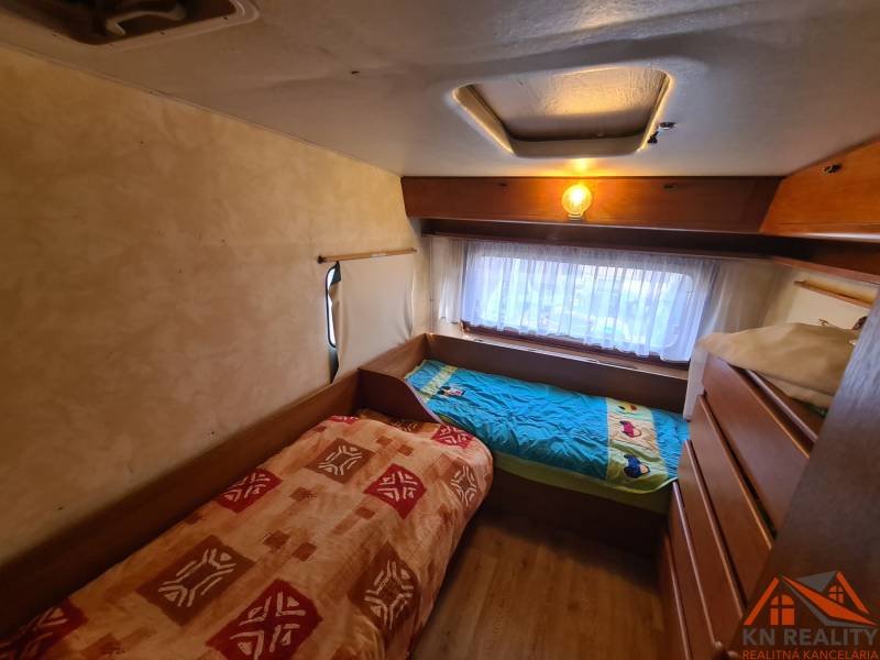 Two beds in a cozy cabin room with a wooden decor floor.