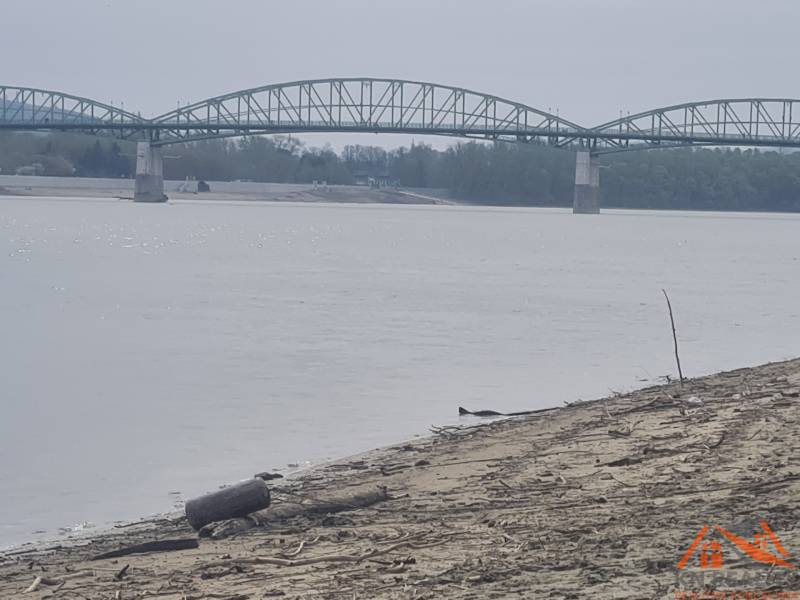 A view of the river and bridge in Štúrovo near the sandy beach.