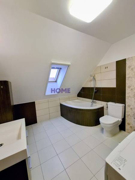 A bathroom with a shower and a bathtub in a 3-room apartment.