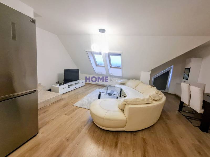Living room with a cream sofa, wood-patterned floor, and a television in a 3-room apartment.