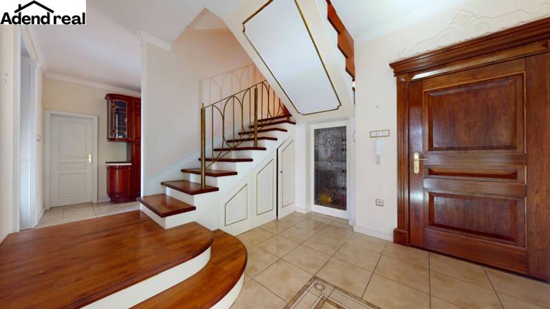 Interior of a 5 or more room apartment with wooden decor flooring and staircase.