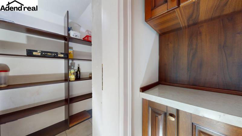 Storage space with shelves and a cabinet with wooden decor in a 5 or more room apartment.