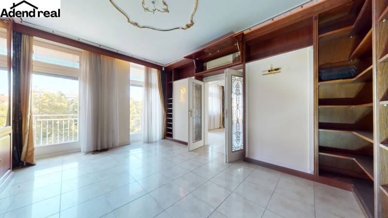 A room with large windows and built-in shelves in a 5 or more room apartment.