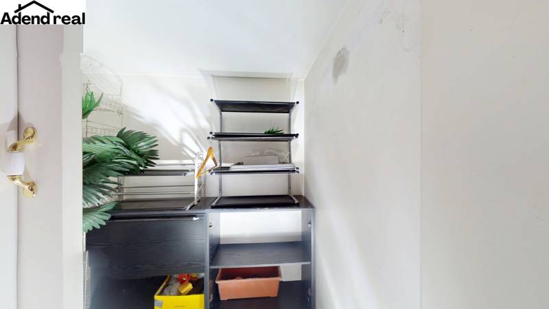 A small room with shelves and artificial plants in a 5 or more room apartment.