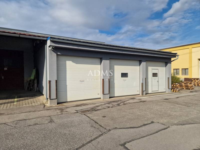 Industrial buildings in Žilina, warehouse and halls with three rolling gates.